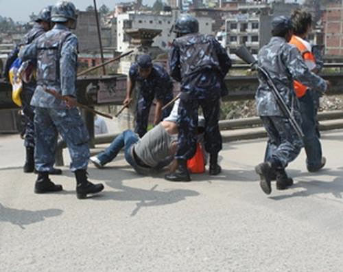 Kathmandu police drag a Tibetan protester