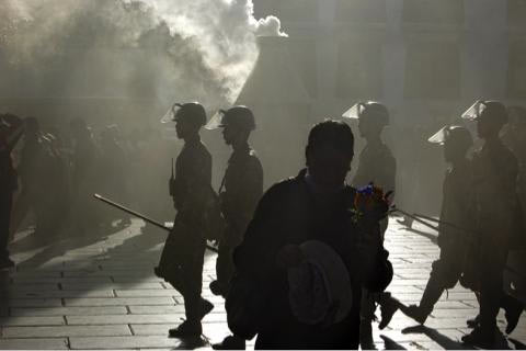 Troops are visible as Tibetan pilgrims gather at the Jokhang temple