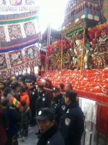 Police stand in front of an altar inside Kumbum monastery