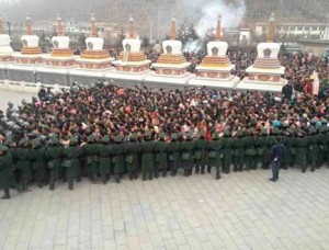 Tibetans surrounded by police as they enter Kumbum monastery.