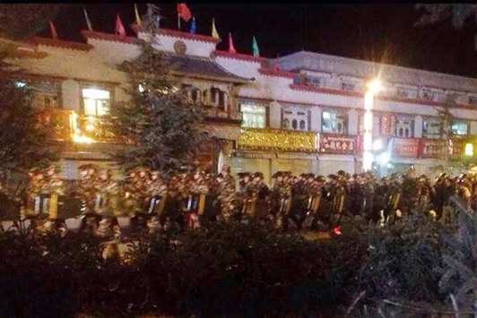 Paramilitary troops in riot gear patrol in the Barkhor area, Lhasa, on December 15, the eve of the Tsongkhapa ‘butter-lamp’ festival.