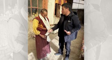 A cadre handing cash to a monastic